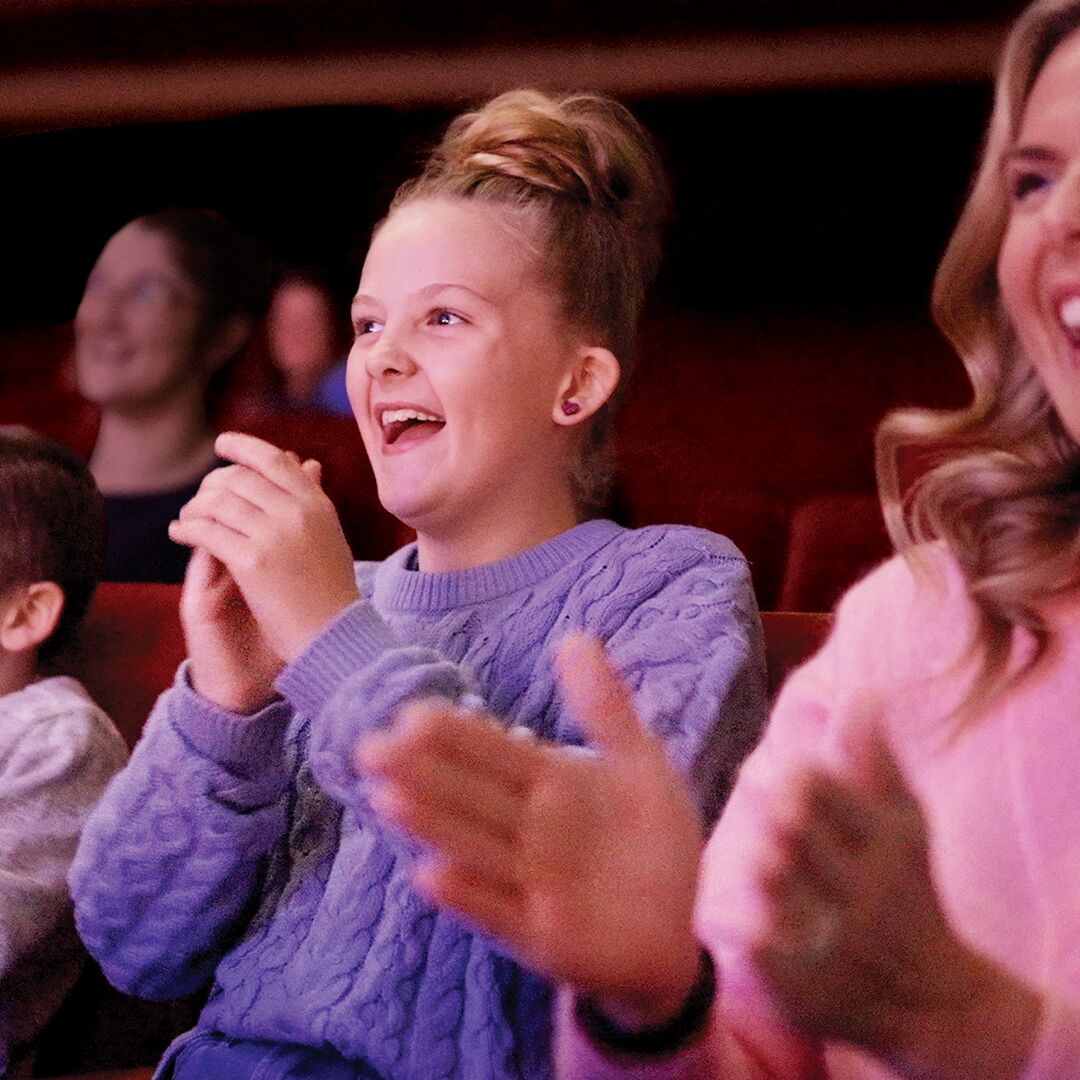 Family clapping along with the show