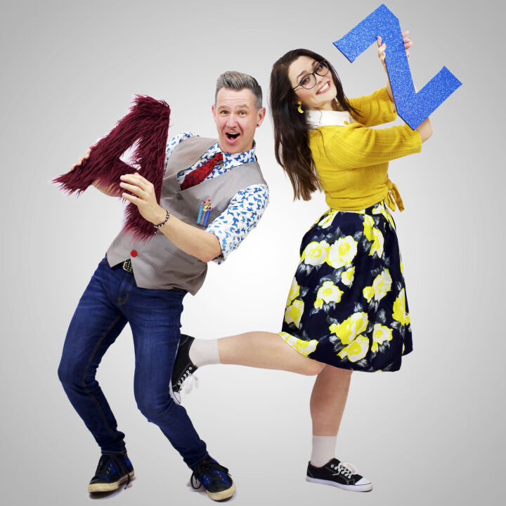 Professors Lexi Con and Noel Edge are taking a promotional image by holding the alphabet.